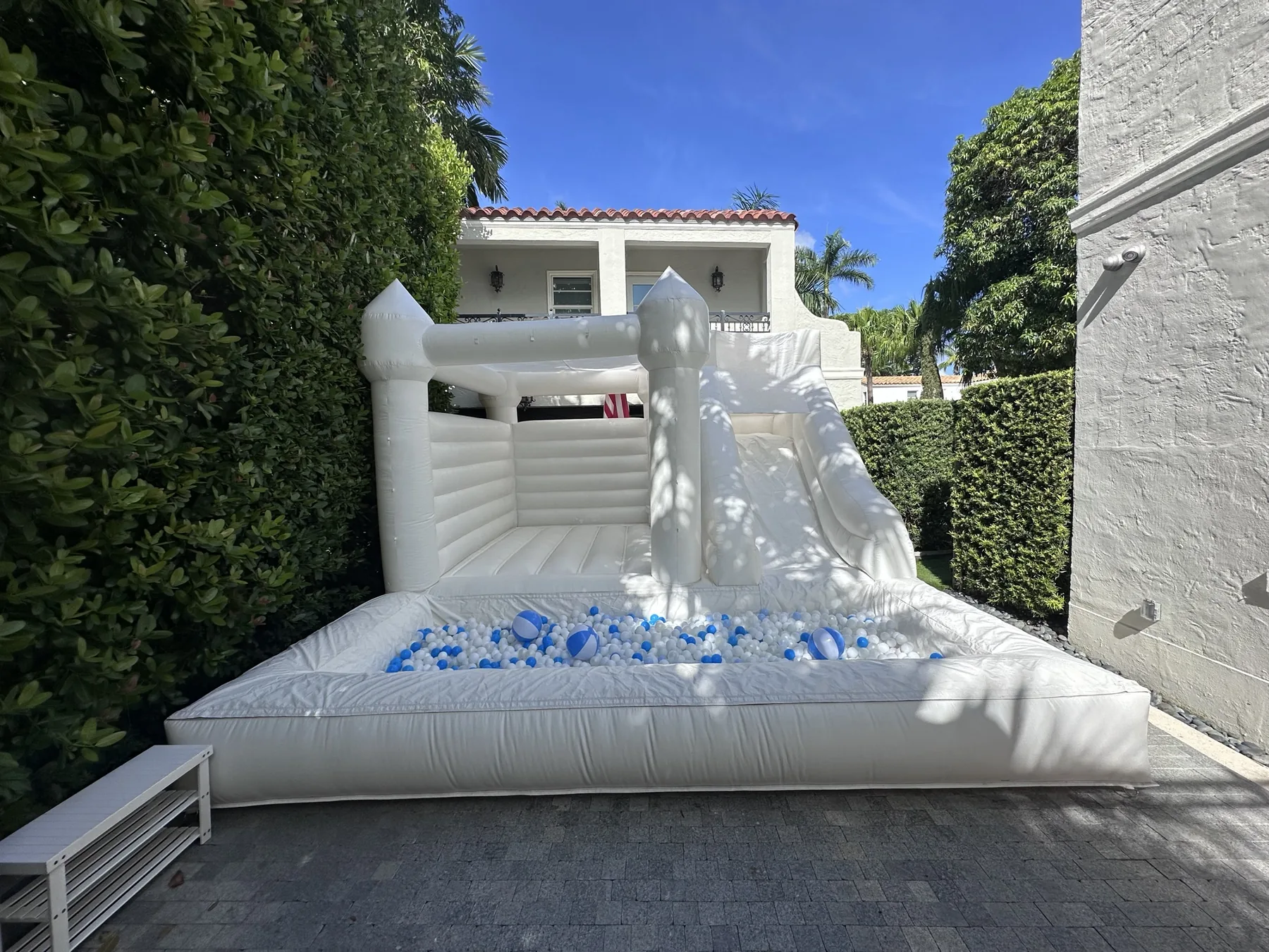 3-in-1 Empire Castle water inflatable rental set up for a kids party in Miami, 16 × 16 ft white — 1 of 6